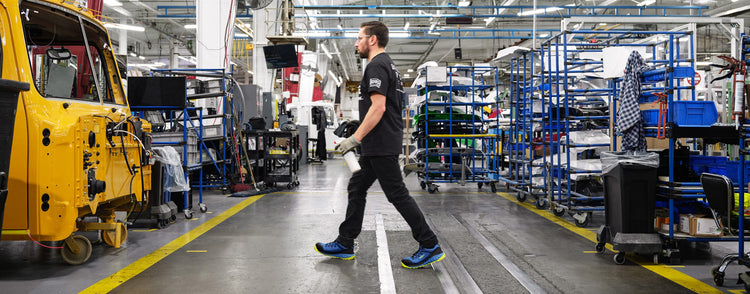 Man walking in Arvada shoes across a cement factory floor