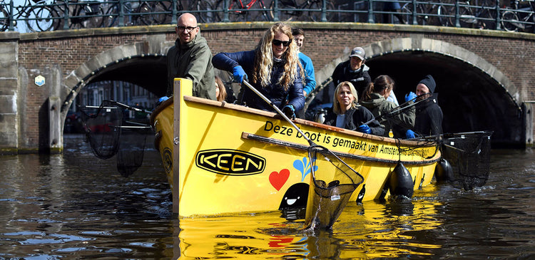 A KEEN team pulling plastic waste out of waterways