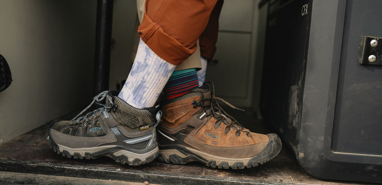 A close-up of a man and woman wearing hiking boots
