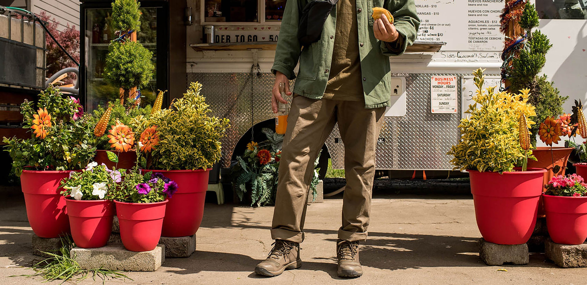 A man standing in front of a garden shop