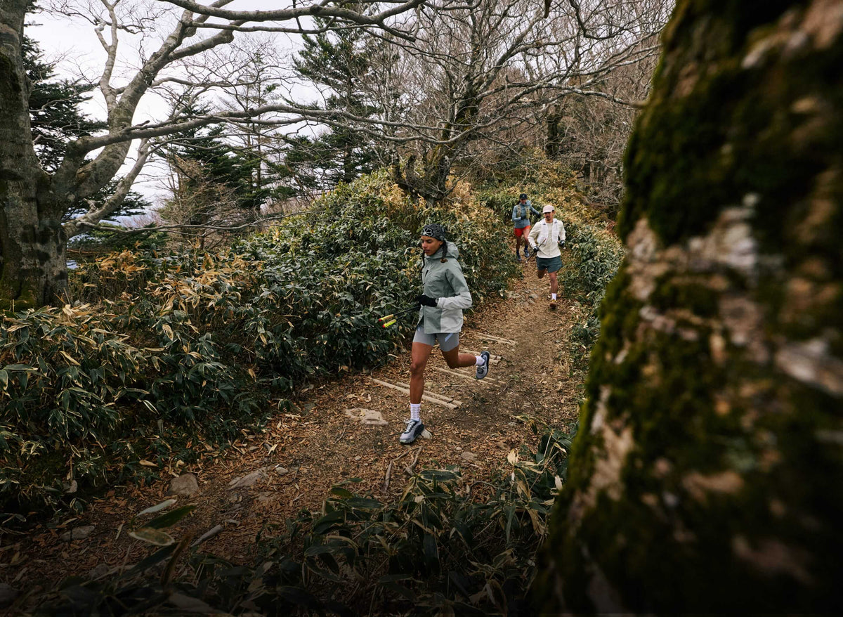 Three people running down trail in KEEN Trail running shoes