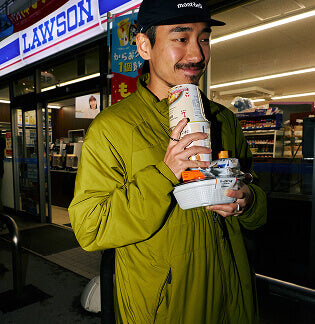 Man walking outside of convenience store holding post run snacks