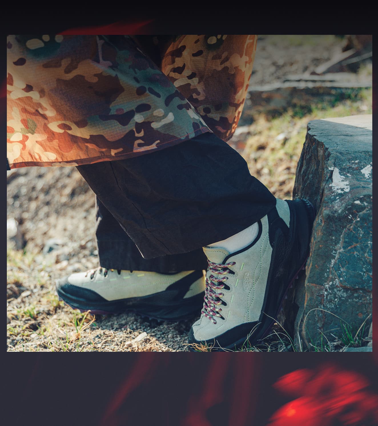 Close up shot of woman wearing a camo skirt over black pants and teal, pink, and black Jasper zionic sneakers.