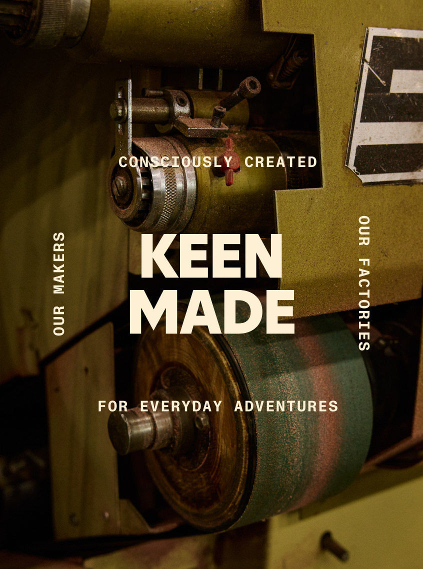 A piece of intricate factory equipment embedded with text that reads "KEEN MADE. Consciously Created. Our Makers. Our Factory. For Everyday Adventures."
