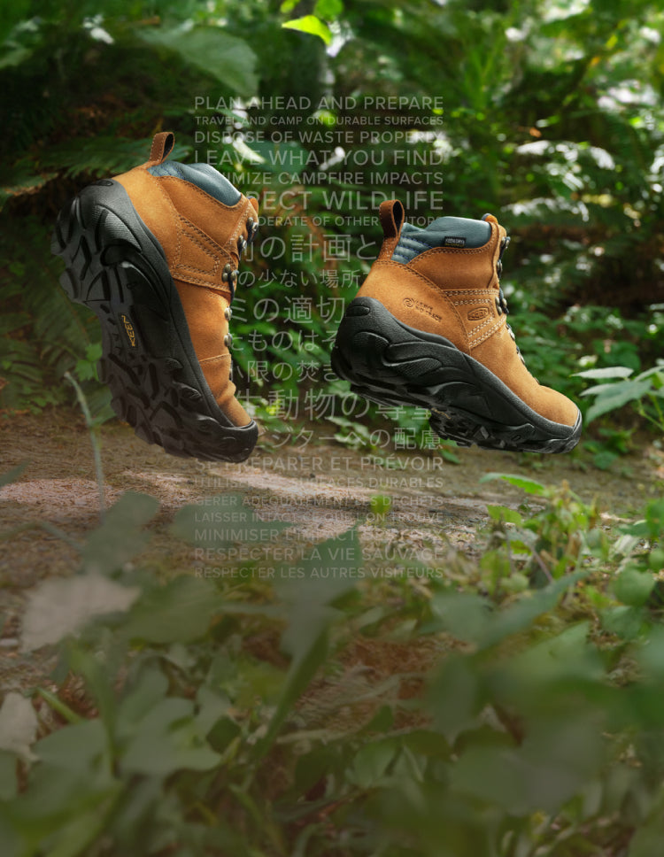 Brown Pyrenees boots on rainforest trail with gradient, multi-language text in background 